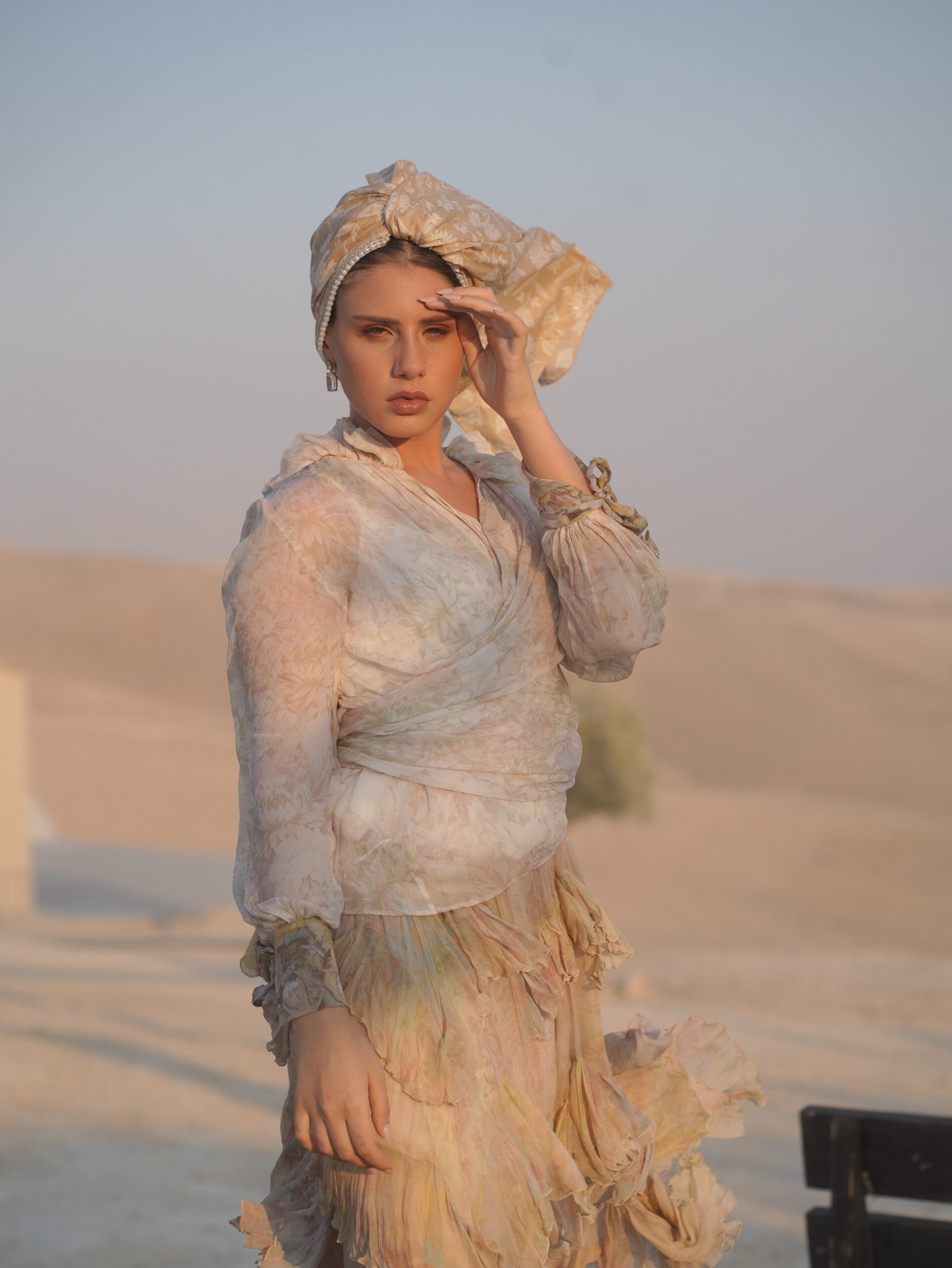 Long royal-cut golden scarf with a subtle floral pattern and pearl-edged borders