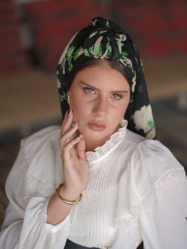 Black scarf with a green floral print